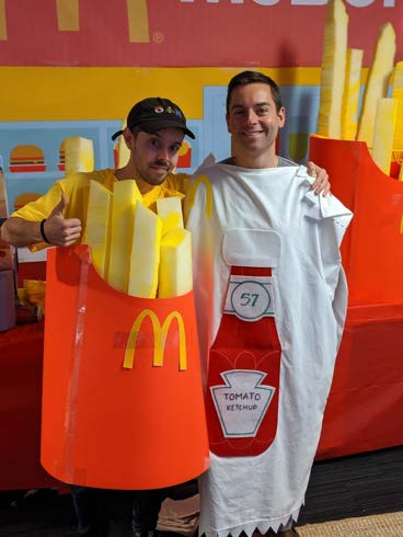 Brendan in a homemade McDonald's french-fries Halloween costume, standing next to a friend dressed as a ketchup packet.